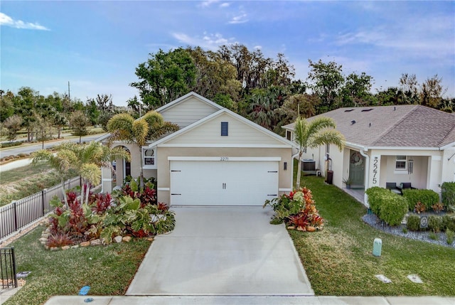 ranch-style house with central air condition unit, fence, concrete driveway, a front yard, and a garage