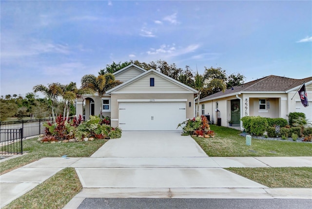 single story home featuring stucco siding, a front lawn, fence, concrete driveway, and a garage