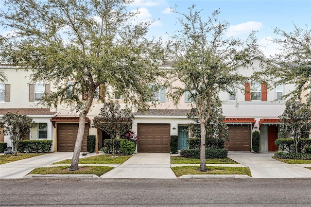 view of property with stucco siding and concrete driveway