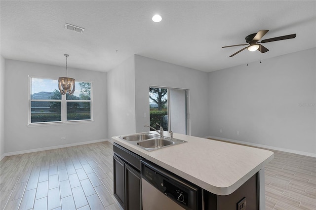 kitchen with open floor plan, dishwasher, light countertops, and a sink