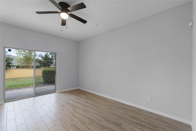 unfurnished room featuring a textured ceiling, baseboards, light wood finished floors, and ceiling fan