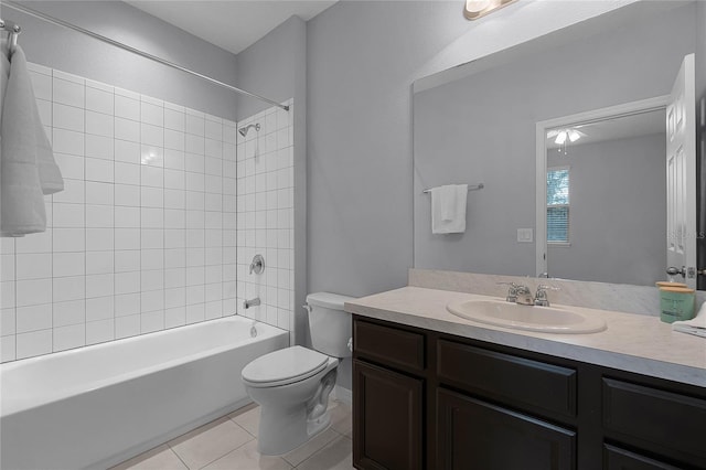 bathroom featuring tile patterned floors, toilet, vanity, and bathing tub / shower combination