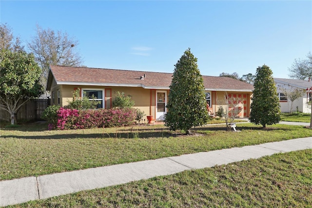 ranch-style house with a front lawn, fence, and stucco siding