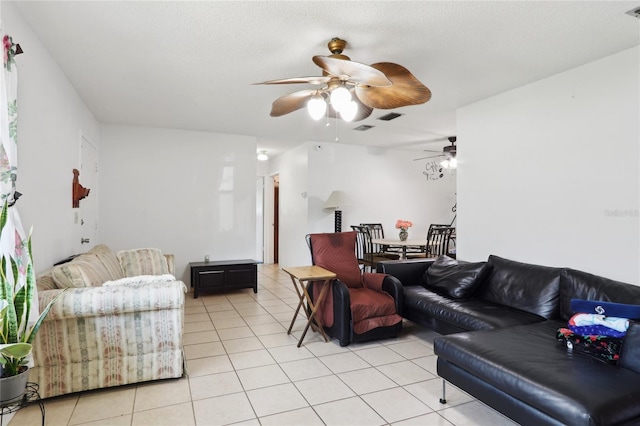 living room featuring ceiling fan, visible vents, and light tile patterned flooring