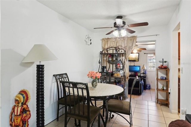 dining space with light tile patterned floors and a ceiling fan