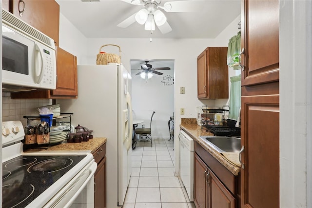 kitchen with backsplash, white appliances, brown cabinets, and a sink