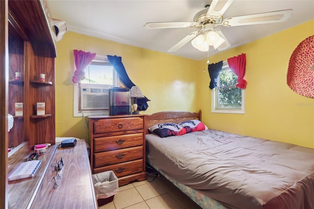 bedroom featuring tile patterned flooring, multiple windows, cooling unit, and a ceiling fan