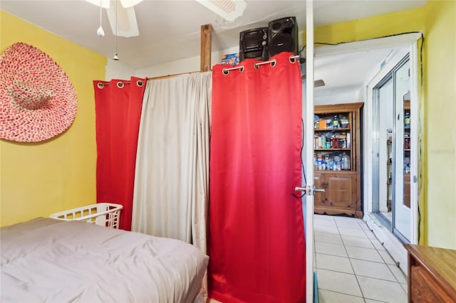 tiled bedroom with ceiling fan