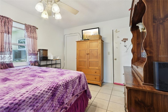 bedroom featuring light tile patterned floors, cooling unit, and a ceiling fan