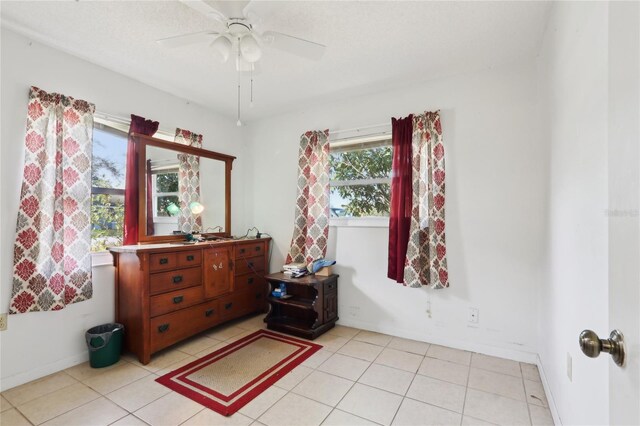 bedroom with light tile patterned floors, baseboards, and ceiling fan