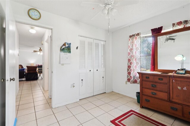 bedroom featuring light tile patterned flooring, baseboards, and a closet