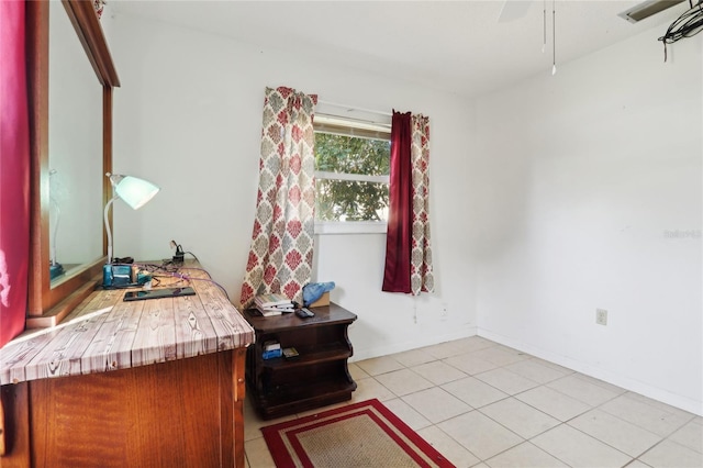 office area featuring light tile patterned flooring, baseboards, and ceiling fan