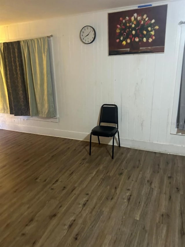 unfurnished room with dark wood-type flooring and baseboards