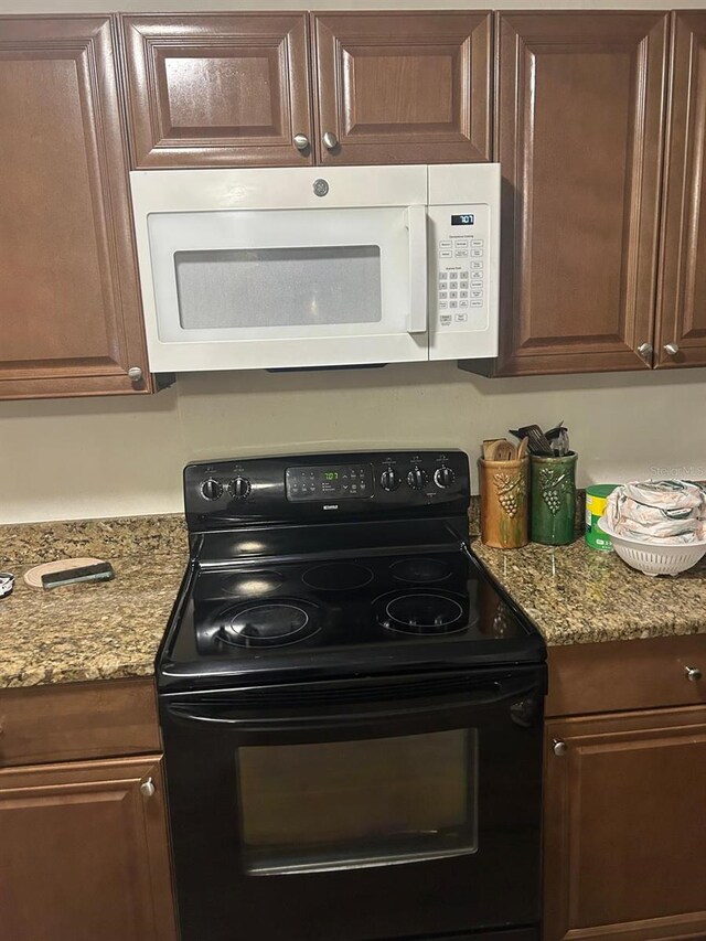 744 Myrtle Ave, Venice, FL 34285 - kitchen featuring electric range and white microwave