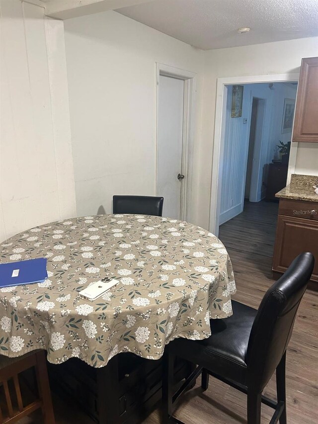 744 Myrtle Ave, Venice, FL 34285 - dining area featuring a textured ceiling and wood finished floors