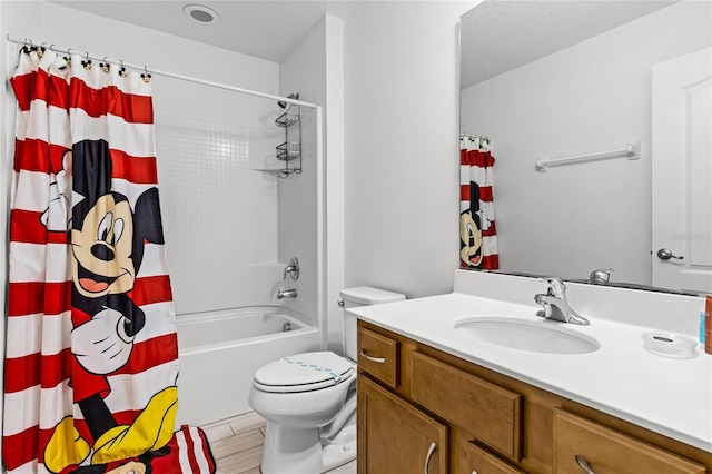 bathroom featuring vanity, toilet, and shower / bathtub combination with curtain