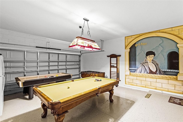 recreation room with billiards, concrete block wall, and a garage