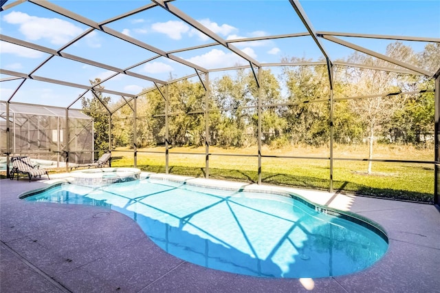 view of pool with a patio area, glass enclosure, a pool with connected hot tub, and a lawn