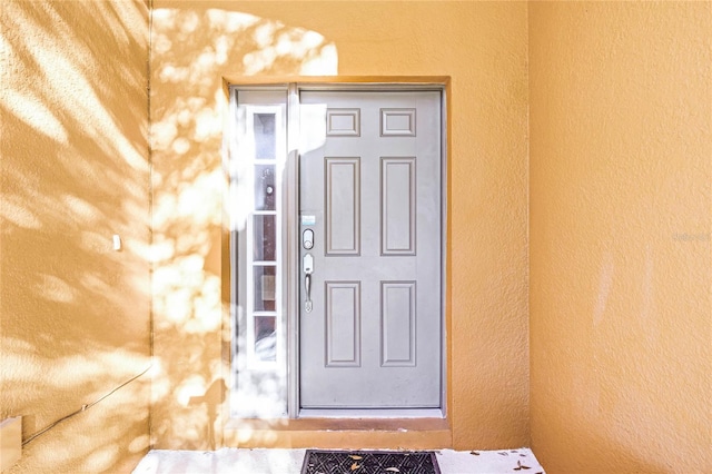 property entrance featuring stucco siding