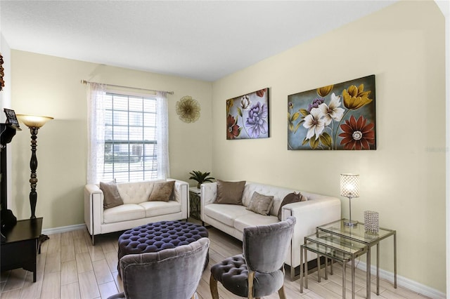 living room with light wood-type flooring and baseboards