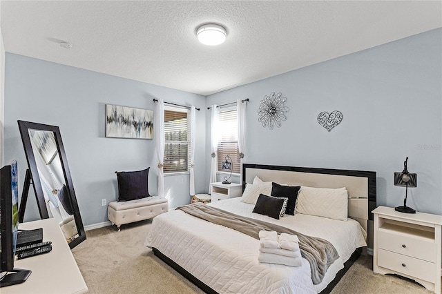 bedroom featuring baseboards, light colored carpet, and a textured ceiling