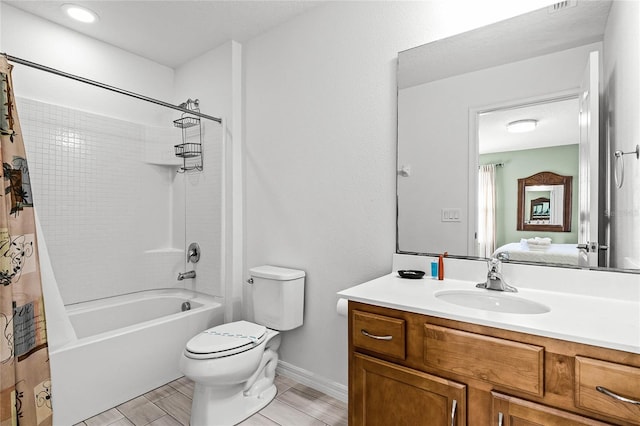 bathroom with vanity, shower / bath combination with curtain, toilet, and baseboards