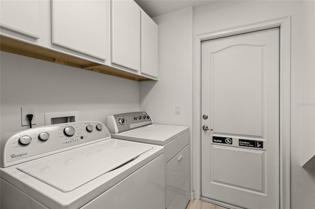 laundry room with cabinet space and independent washer and dryer