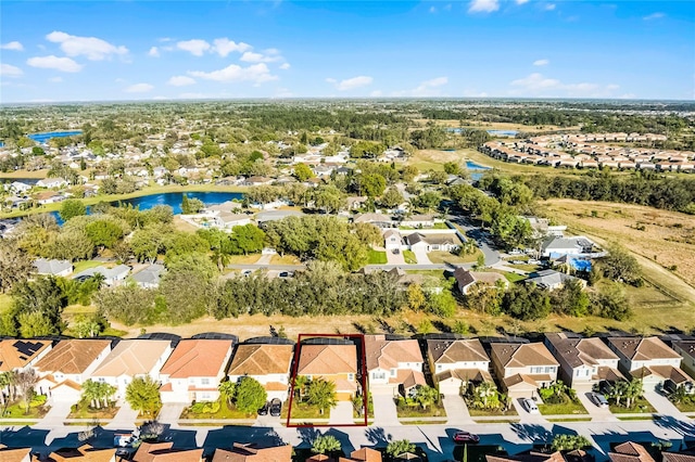 drone / aerial view featuring a residential view and a water view