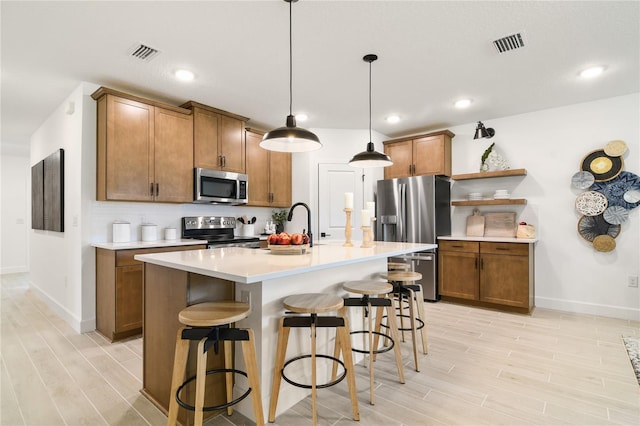 kitchen featuring brown cabinetry, visible vents, and stainless steel appliances