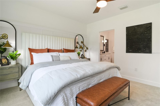 bedroom with carpet, visible vents, baseboards, ensuite bath, and ceiling fan