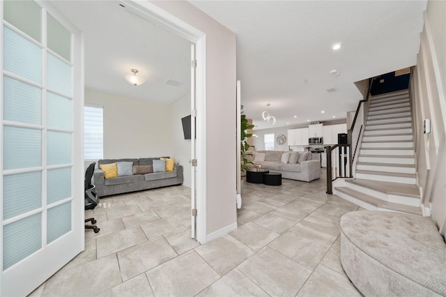 interior space with a wealth of natural light, stairway, visible vents, and recessed lighting