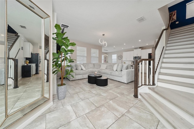 living area with stairway and visible vents