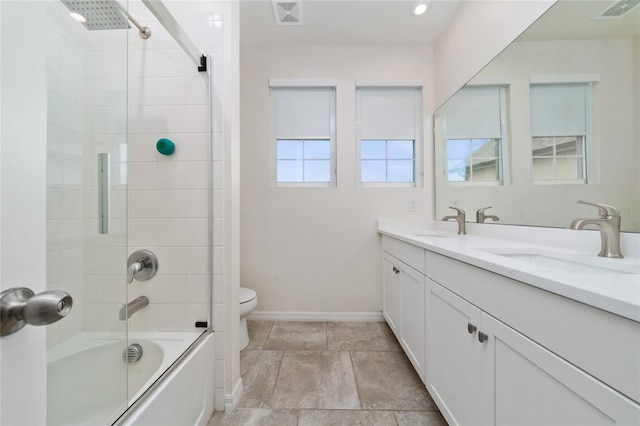 full bath featuring a sink, visible vents, toilet, and double vanity