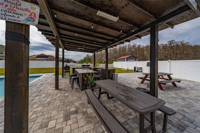 view of patio / terrace featuring a fenced in pool, outdoor dining area, and a fenced backyard