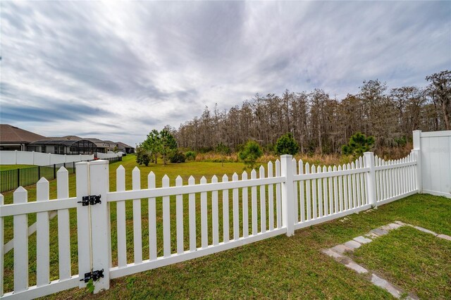 view of yard with fence private yard and a gate