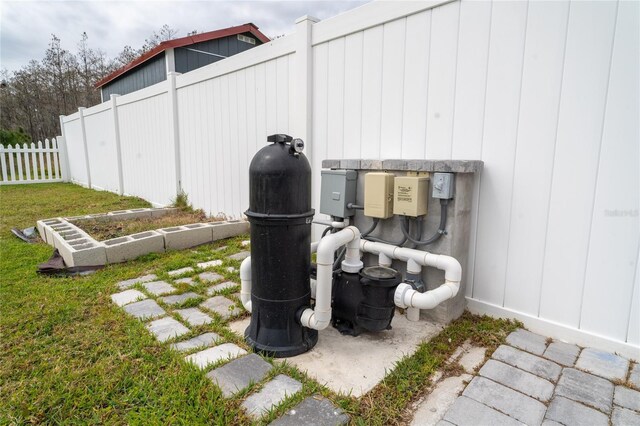 exterior details featuring pump and fence