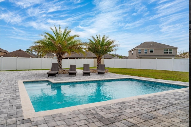 view of pool featuring a fenced backyard, a fenced in pool, a lawn, and a patio