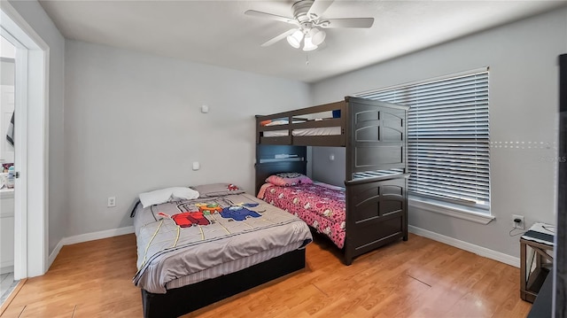 bedroom featuring baseboards, light wood-style floors, and a ceiling fan