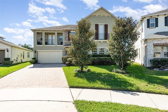 view of front of home featuring a front yard, decorative driveway, an attached garage, and stucco siding