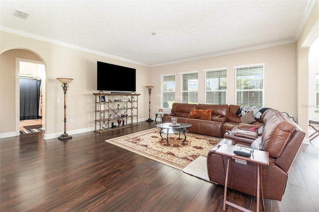 living area featuring wood finished floors, visible vents, arched walkways, and baseboards