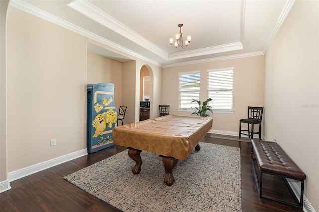 game room featuring a raised ceiling, baseboards, arched walkways, and dark wood-style flooring