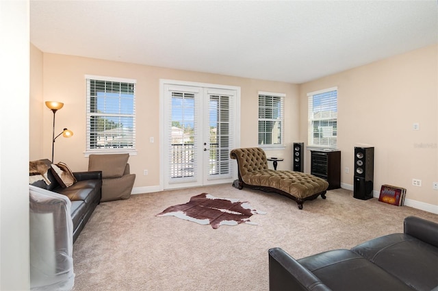 living room featuring french doors, baseboards, a healthy amount of sunlight, and carpet flooring