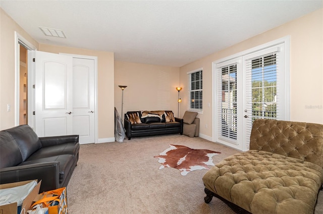 living room with carpet flooring, baseboards, and visible vents