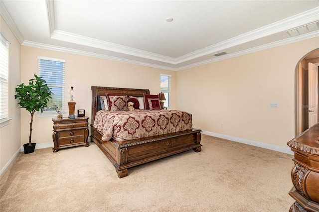 bedroom featuring baseboards, visible vents, arched walkways, and light carpet