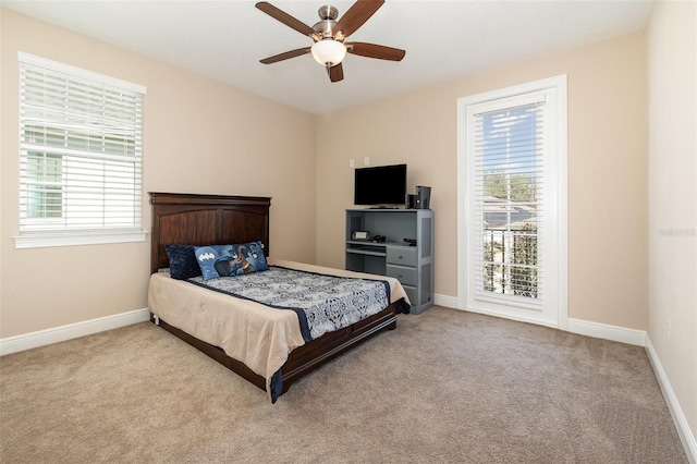 bedroom featuring multiple windows, baseboards, and carpet