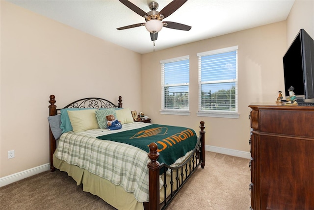 carpeted bedroom with a ceiling fan and baseboards