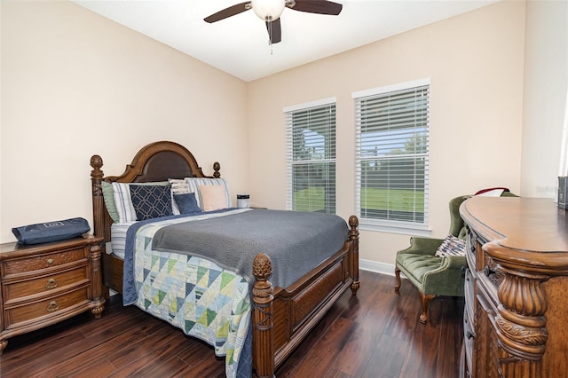 bedroom with a ceiling fan, wood finished floors, and baseboards