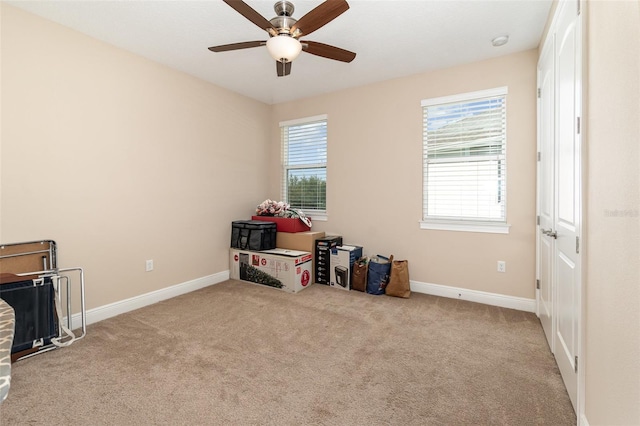 game room featuring baseboards, a ceiling fan, a healthy amount of sunlight, and carpet flooring