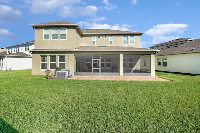 back of property featuring stucco siding, a lawn, cooling unit, and a sunroom