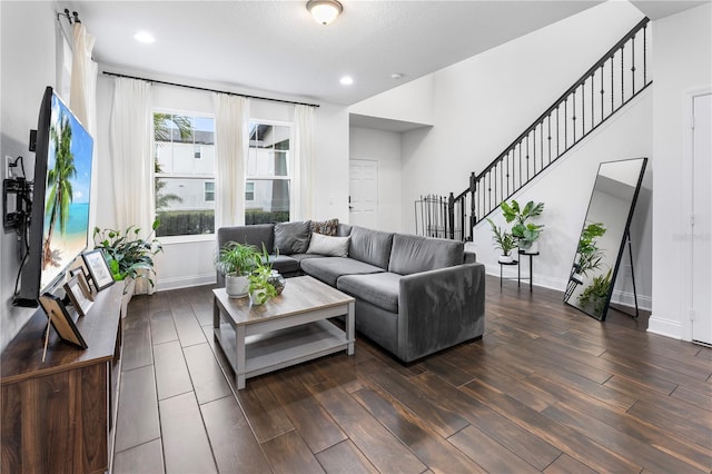 living area featuring stairs, dark wood-type flooring, recessed lighting, and baseboards